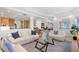 Bright living room boasts stylish sofas, a decorative rug, and an open floor plan into the kitchen at 6130 Kipps Colony W Dr, Gulfport, FL 33707