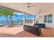 Relax on this patio overlooking the water, complete with comfortable seating, a pool, and a covered area at 6130 Kipps Colony W Dr, Gulfport, FL 33707
