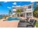 Backyard oasis with a luxurious pool, waterfront views, and outdoor seating for relaxation and entertaining at 6130 Kipps Colony W Dr, Gulfport, FL 33707