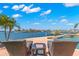 Enjoy the serene waterfront views from this luxury home's pool and outdoor seating area at 6130 Kipps Colony W Dr, Gulfport, FL 33707
