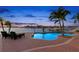 Enjoy spectacular water views from this home's outdoor sitting area near pool at 6130 Kipps Colony W Dr, Gulfport, FL 33707
