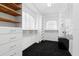 Well-organized walk-in closet offering ample storage with wooden shelving and drawers at 6130 Kipps Colony W Dr, Gulfport, FL 33707