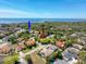 Beautiful aerial view of neighborhood homes, Howard Park, and the clear blue waters of the gulf coast at 631 Baynard Dr, Tarpon Springs, FL 34689