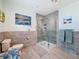 Contemporary bathroom showcasing a glass shower and tiled walls and floors at 631 Baynard Dr, Tarpon Springs, FL 34689
