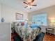 Cozy bedroom with a ceiling fan, large window, and a vanity area at 631 Baynard Dr, Tarpon Springs, FL 34689