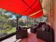Screened patio boasts comfortable seating under a stylish sunshade at 631 Baynard Dr, Tarpon Springs, FL 34689