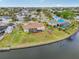 Lovely aerial view of the property with canal access, a screened-in patio, and well-maintained lawn at 6357 Spanish Main Dr, Apollo Beach, FL 33572