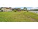 Sprawling backyard featuring lush green grass and a screened in lanai overlooking the canal at 6357 Spanish Main Dr, Apollo Beach, FL 33572