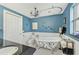 Elegant bathroom featuring a clawfoot tub with unique leaf decorations and a chandelier at 6357 Spanish Main Dr, Apollo Beach, FL 33572