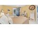 Bright bedroom features a comfortable seating area and a door with access to the bathroom at 6357 Spanish Main Dr, Apollo Beach, FL 33572