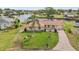 Scenic exterior featuring a cozy home, lush lawn, waterway and boat docks at 6357 Spanish Main Dr, Apollo Beach, FL 33572