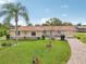 Inviting exterior showcasing the well-maintained lawn, brick driveway and attached garage at 6357 Spanish Main Dr, Apollo Beach, FL 33572