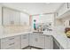 Bright kitchen with white cabinets, marble countertops, and a view to the outside at 6357 Spanish Main Dr, Apollo Beach, FL 33572