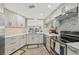 Modern kitchen featuring white cabinets, stainless steel appliances, and a stylish backsplash at 6357 Spanish Main Dr, Apollo Beach, FL 33572