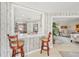 View of a modern kitchen through a bar, featuring white cabinets and a stylish countertop at 6357 Spanish Main Dr, Apollo Beach, FL 33572