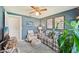 Cozy living room features a comfortable plaid sofa and a view into an open doorway at 6357 Spanish Main Dr, Apollo Beach, FL 33572