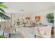 Bright living room with palm accents, refined furniture, and access to more living space at 6357 Spanish Main Dr, Apollo Beach, FL 33572
