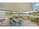 Covered screened patio with outdoor seating and a beautiful water view beyond at 6357 Spanish Main Dr, Apollo Beach, FL 33572