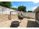 Outdoor patio area featuring brick pavers, outdoor gazebo, privacy fencing, and landscaped retaining wall at 6831 Greenwich Ave, New Port Richey, FL 34653