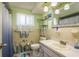 Well-lit bathroom featuring a vanity with sink, toilet, tile accents, and decorative marine-themed elements at 6831 Greenwich Ave, New Port Richey, FL 34653