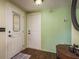 Bright foyer with wood floors, featuring a decorative glass front door and neutral decor at 6831 Greenwich Ave, New Port Richey, FL 34653
