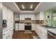 Bright kitchen with modern appliances, tile backsplash and unique lighting fixture at 6831 Greenwich Ave, New Port Richey, FL 34653