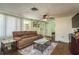 Spacious living room with neutral colors and a brick fireplace, perfect for relaxation and entertaining at 6831 Greenwich Ave, New Port Richey, FL 34653