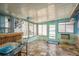 Enclosed sunroom features tile flooring, lots of natural light, and beach-themed decor at 6831 Greenwich Ave, New Port Richey, FL 34653