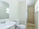 Clean bathroom featuring a large mirror and walk-in shower at 7338 Coventry Dr, Port Richey, FL 34668