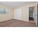 Bedroom with carpet flooring, closet, and a window at 7338 Coventry Dr, Port Richey, FL 34668
