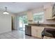 Kitchen featuring stainless steel appliances and a sliding door to the backyard at 7338 Coventry Dr, Port Richey, FL 34668