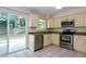 Updated kitchen featuring stainless steel appliances and a sliding door to the backyard at 7338 Coventry Dr, Port Richey, FL 34668