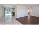 Open living space with vinyl and tile flooring leading to the kitchen and backyard access at 7338 Coventry Dr, Port Richey, FL 34668