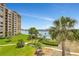 Aerial view of the condo backyard and waterfront featuring lush landscaping and a pool at 736 Island Way # 303, Clearwater Beach, FL 33767