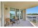 Balcony view showcasing outdoor seating and a waterfront view at 736 Island Way # 303, Clearwater Beach, FL 33767