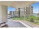 Comfortable balcony with a beautiful view of a green common area and a neighboring building at 736 Island Way # 303, Clearwater Beach, FL 33767