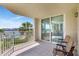 Spacious tiled balcony with seating area offering beautiful views of the bay and nearby community at 736 Island Way # 303, Clearwater Beach, FL 33767
