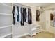 Walk-in closet with ample shelving and hanging space for organized storage at 736 Island Way # 303, Clearwater Beach, FL 33767