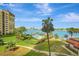 Stunning waterfront condo with lush landscaping, pool, boat docks, and views of the bay at 736 Island Way # 303, Clearwater Beach, FL 33767