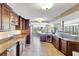Spacious kitchen featuring brown cabinets, stainless steel appliances, stone countertops and an island at 736 Island Way # 303, Clearwater Beach, FL 33767
