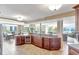 Open kitchen showcasing a cooktop island, custom wood cabinetry, and water views at 736 Island Way # 303, Clearwater Beach, FL 33767