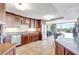 Spacious kitchen featuring brown cabinets, stainless steel appliances, and stone countertops at 736 Island Way # 303, Clearwater Beach, FL 33767