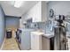 Well-equipped laundry room features sleek washer and dryer, ample storage and organization solutions at 736 Island Way # 303, Clearwater Beach, FL 33767