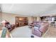 Comfortable living room with brown leather furniture, and convenient access to a kitchen bar at 736 Island Way # 303, Clearwater Beach, FL 33767