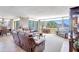 Living room boasts neutral tones, tile floors, and panoramic water views at 736 Island Way # 303, Clearwater Beach, FL 33767