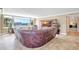 Spacious living room with leather furniture, tile flooring, and a picturesque water view at 736 Island Way # 303, Clearwater Beach, FL 33767
