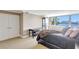 Bedroom featuring large windows with water views, a king bed, and convenient closet access at 736 Island Way # 303, Clearwater Beach, FL 33767