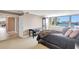 Bright main bedroom featuring a king bed, ample closet space, and a beautiful water view at 736 Island Way # 303, Clearwater Beach, FL 33767