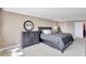 Spacious main bedroom with a king bed, dresser, and a decorative lizard accent piece at 736 Island Way # 303, Clearwater Beach, FL 33767