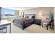 Bedroom featuring large windows with water views, a king bed, and elegant dark wood furniture at 736 Island Way # 303, Clearwater Beach, FL 33767